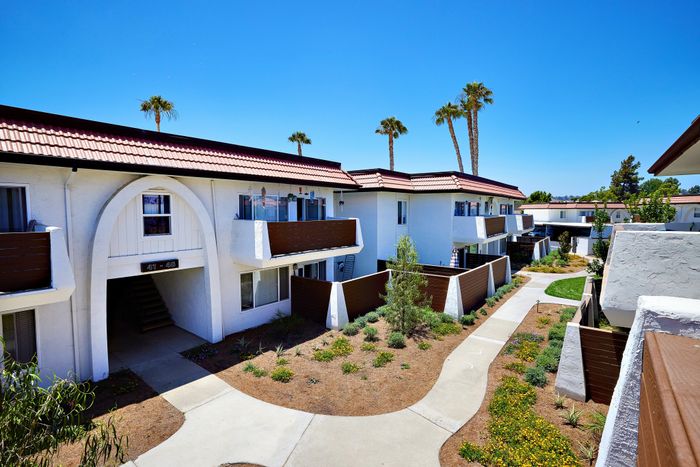 view over balcony of lush grounds and bright blue sky