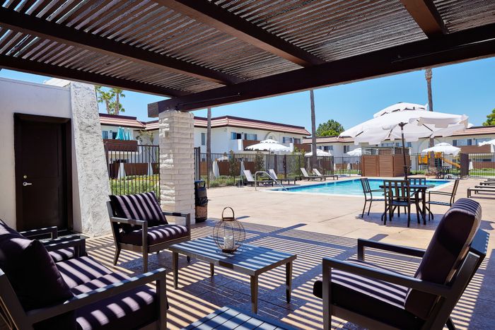 view from shaded pergola to pool and playground