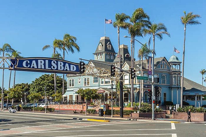 carlsbad sign with blue house in the back