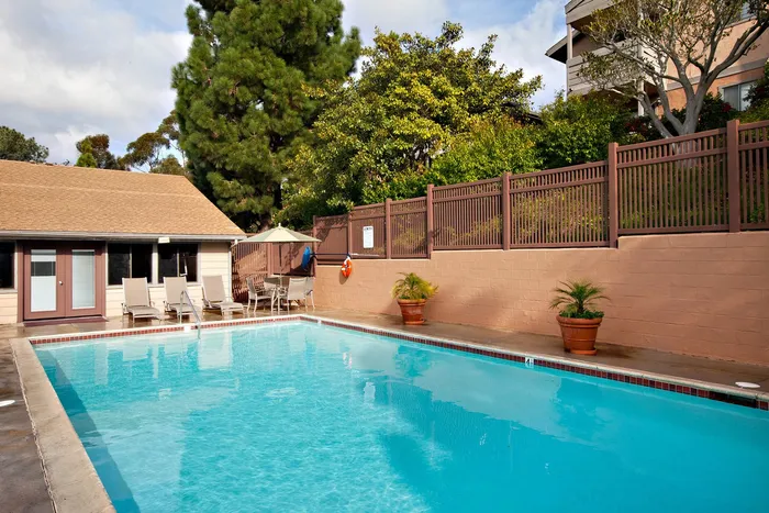 Poolside view featuring comfortable lounge seating for resident relaxation.