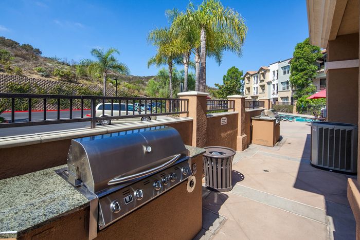 Outdoor community BBQ grill and picnic area located near the pool and spa.