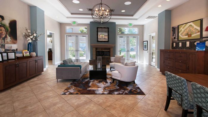Stylish community clubhouse featuring comfortable lounge seating and a fireplace for resident gatherings.