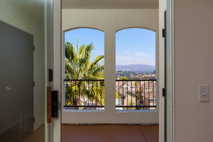 View from a private apartment balcony overlooking the lushly landscaped grounds and neighborhood.