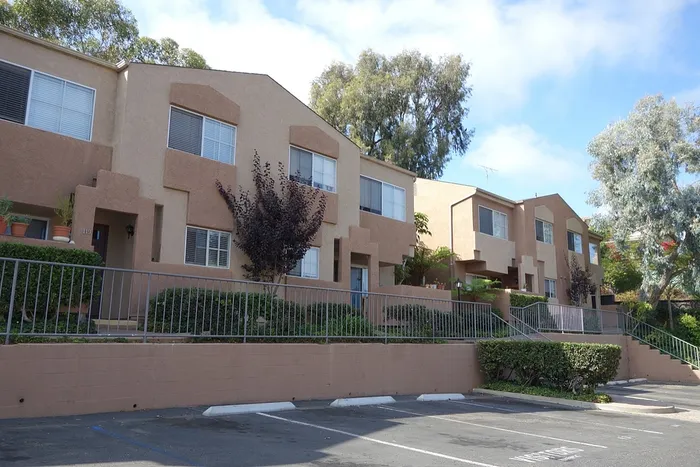 Exterior view of a community building featuring a row of attached garages available for residents.