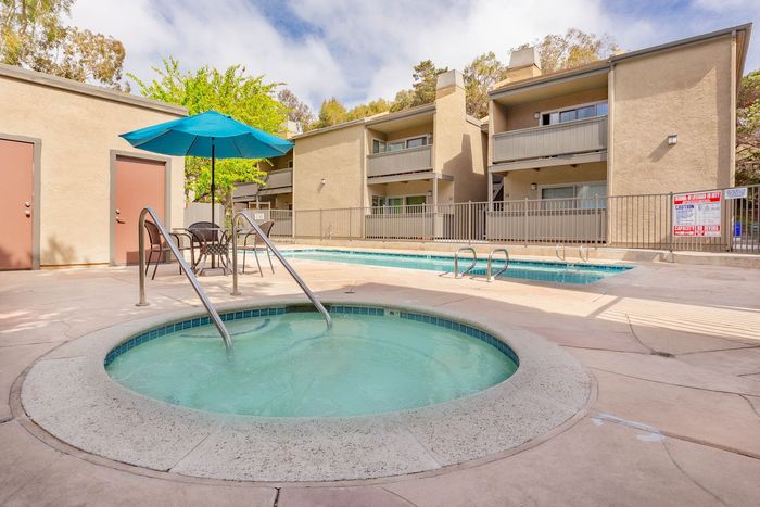 Refreshing circular outdoor spa and hot tub area located next to the swimming pool.