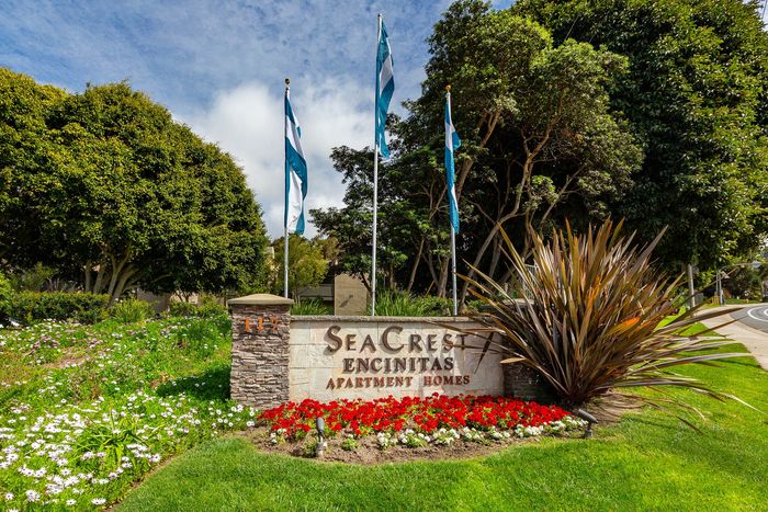 Elan Seacrest Encinitas community entrance signage featuring colorful flower beds and manicured lawns.