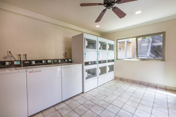 Bright and spacious on-site laundry facility with multiple professional-grade machines.