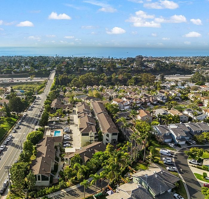 An aerial view of the Encinitas Terrace apartment complex, showing its prime location near the coast and surrounding residential neighborhood.