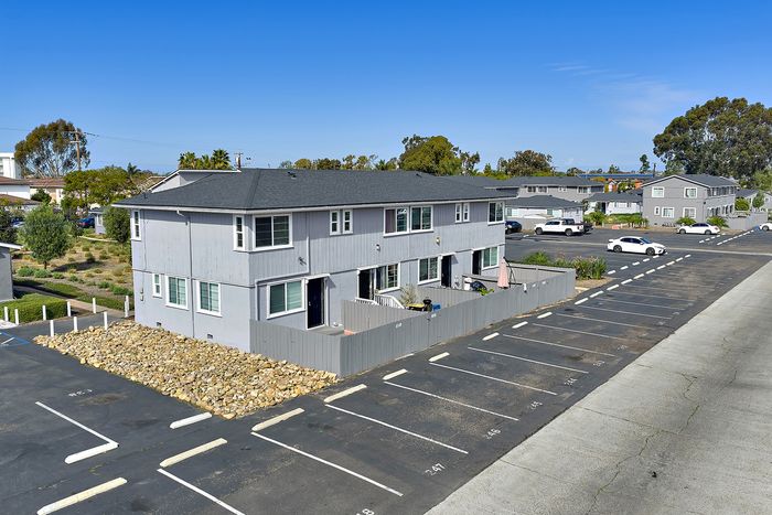 Village Apartments showing property with parking lot and surrounding area.
