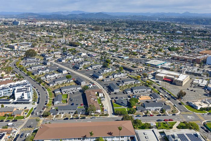 Aerial Shot showing property and neighborhood, including homes and local businesses
