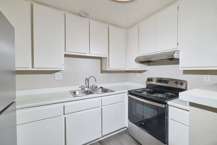 Kitchen with refrigerator, sink, and oven