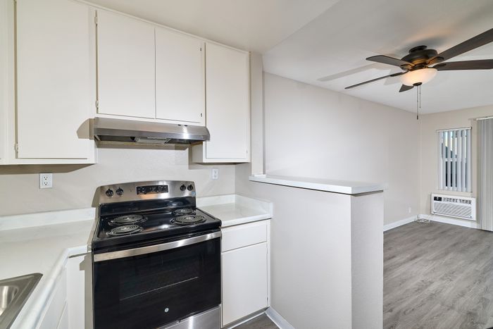 Kitchen open plan with living space and wooden floors and ceiling fan