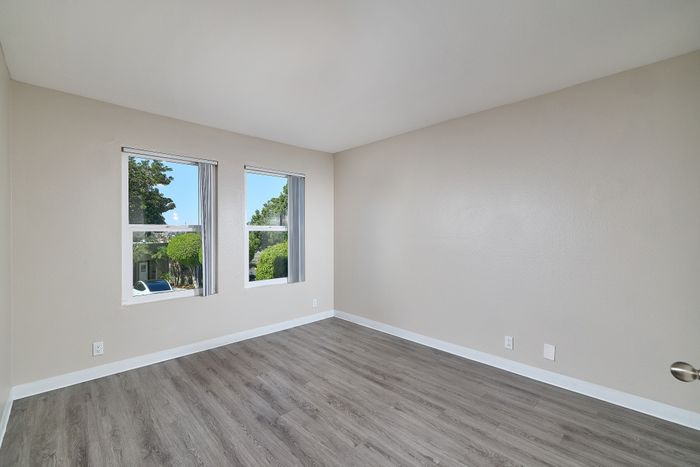 Bedroom with wooden floors and windows