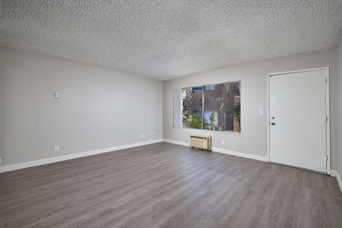 living area with wooden floor and window