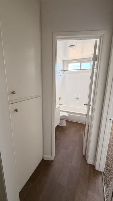 Hallway at Vogue Manor with a linen closet and bathroom