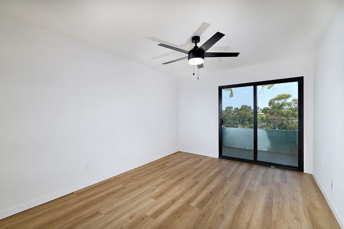 Bedroom at Melrose Canyon one-bedroom with balcony and ceiling fan