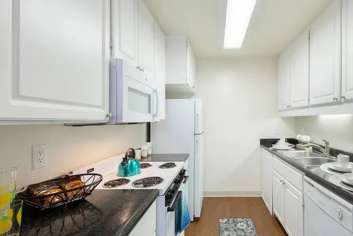 Kitchen featuring white appliances and counters at Elan - Scripps Terrace.