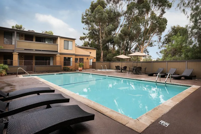 Refreshing swimming pool with lounge chairs at Elan - Scripps Terrace.