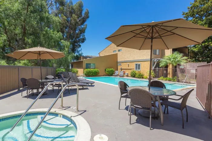 Relaxing spa and patio seating by the pool at Elan - Scripps Terrace.