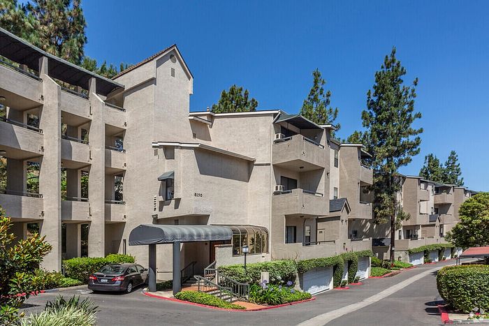Multi-story apartment building with lush landscaping at Elan - Terraza La Jolla