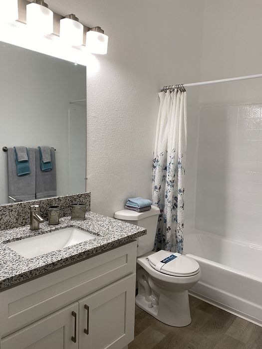 Modern bathroom vanity and tub-shower combo at Elan - Terraza La Jolla
