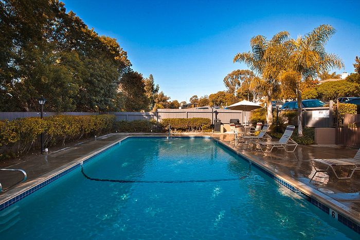 Refreshing blue pool and tropical landscaping at sunset at Elan - Sandpiper Del Mar