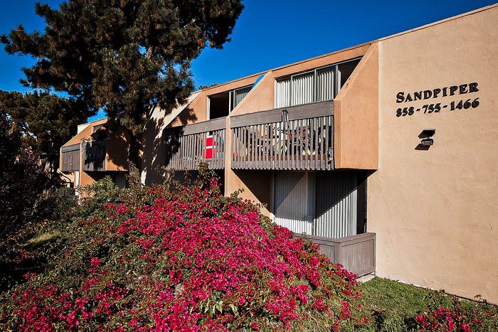 Coastal building with blooming bougainvillea and balconies at Elan - Sandpiper Del Mar