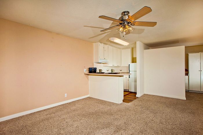 Open layout with kitchen and plush carpet at Elan - Sandpiper Del Mar