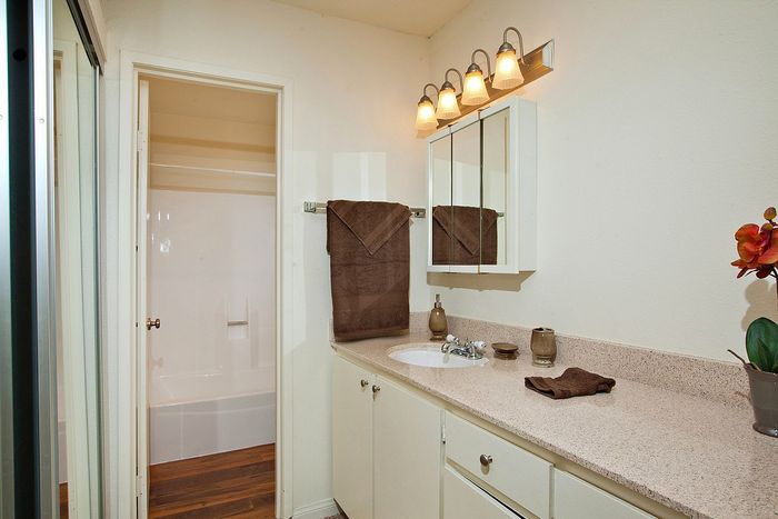 Modern bathroom vanity and large mirror at Elan - Sandpiper Del Mar