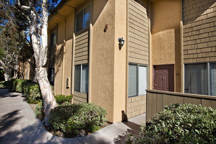 Multi-story apartment exterior with private balconies at Elan - Solana Pointe.