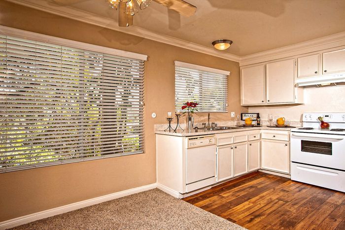Bright kitchen featuring white cabinetry and window at Elan - Solana Pointe.