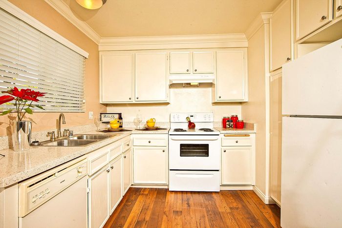 Fully equipped kitchen with clean white finishes at Elan - Solana Pointe.