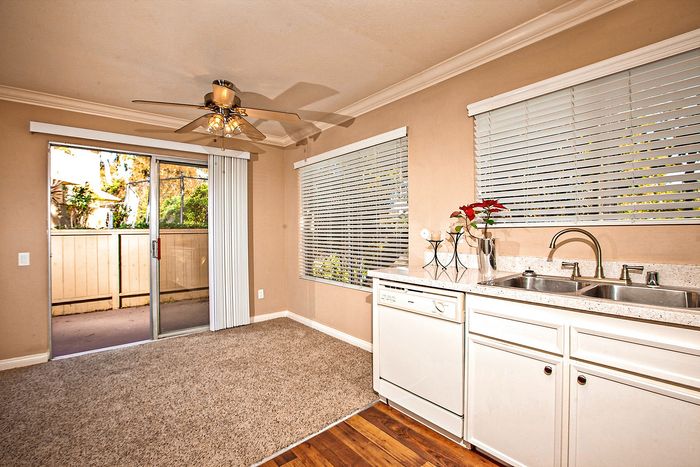Dining space with ceiling fan and patio access at Elan - Solana Pointe.
