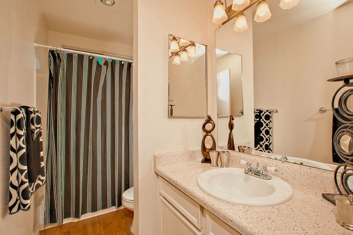 Modern bathroom vanity and well-lit mirror at Elan - Solana Pointe.