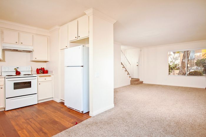 Open-concept kitchen with white appliances at Elan - Solana Pointe.