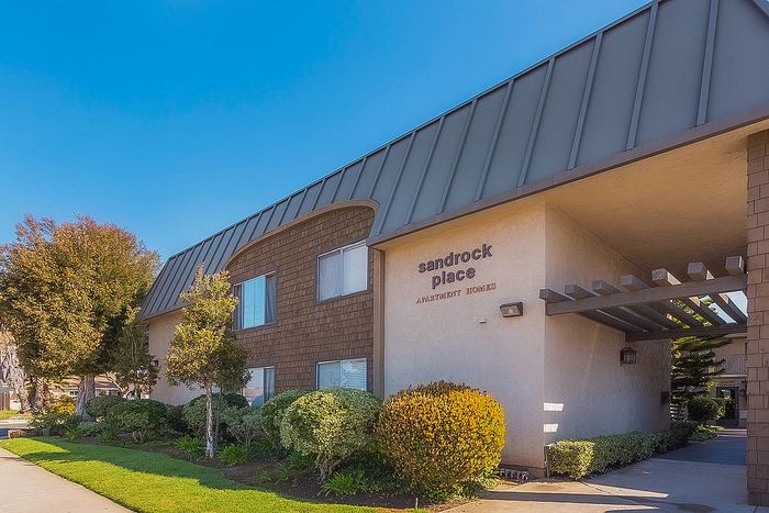 Modern apartment building exterior with professional landscaping at Elan - Sandrock Place