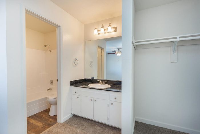 Clean bathroom vanity and spacious closet storage at Elan - Sandrock Place
