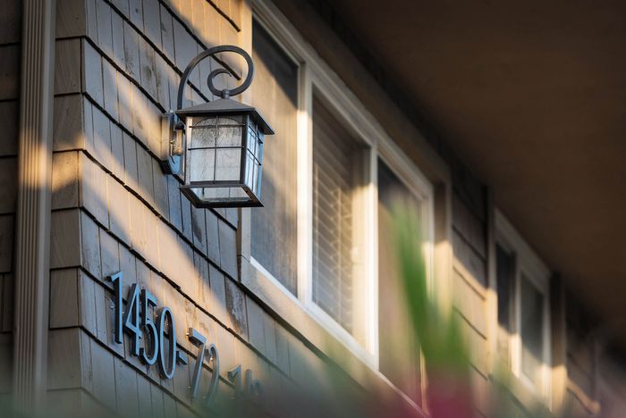 Warmly lit building exterior and decorative lighting at night at Elan - Baylofts