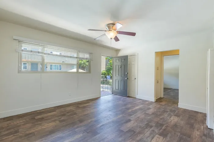 Living area featuring a ceiling fan and modern flooring at Elan - Baylofts