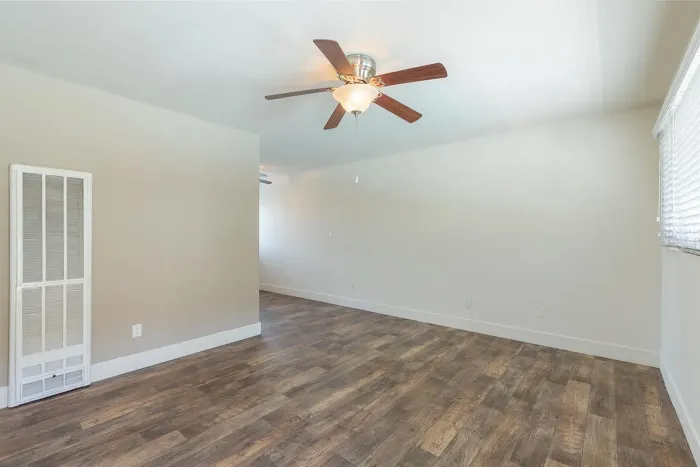 Spacious apartment interior with neutral walls and ceiling fan at Elan - Baylofts