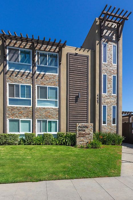 Modern multi-story building architecture and blue skies at Elan - pacific lofts