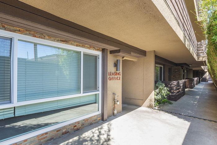 Apartment building exterior with landscaped walkways and unit entry at Elan - pacific lofts