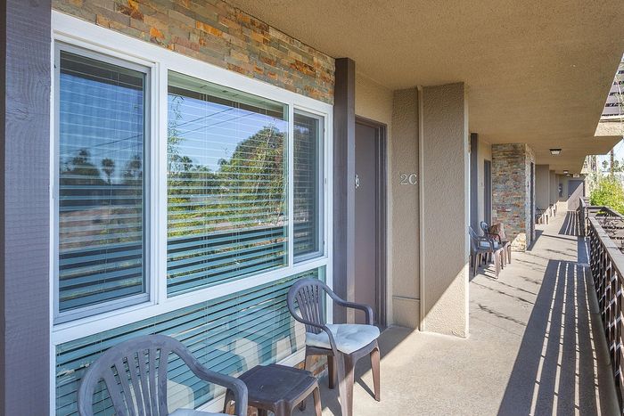 Private resident balcony with patio furniture and outdoor views at Elan - pacific lofts