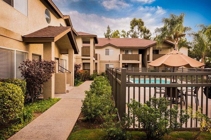 Gated pool area surrounded by professional landscaping at Elan - poway hills.