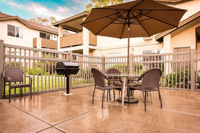 Community BBQ and picnic area with shaded outdoor seating at Elan - poway hills.