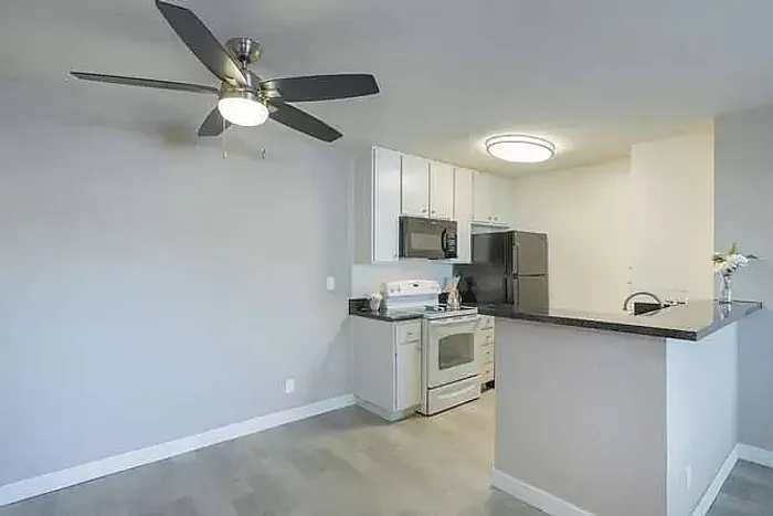 Kitchen and dining area featuring a ceiling fan and modern flooring at Elan - poway hills.