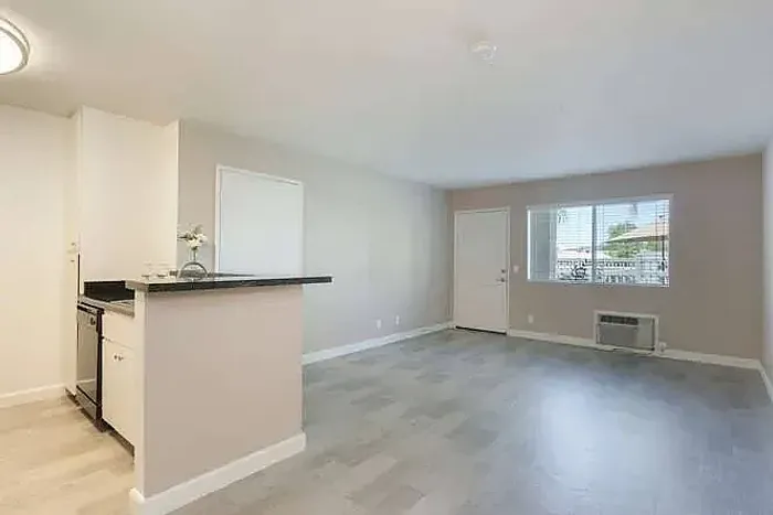 Kitchen with a breakfast bar and white cabinetry at Elan - poway hills.