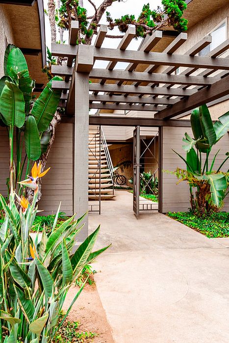 Tropical walkway under a wooden pergola and stairs at Elan - beachhouse del mar