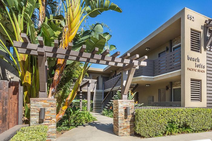 Decorative wooden trellis and landscaped property entrance at Elan - beachlofts del mar