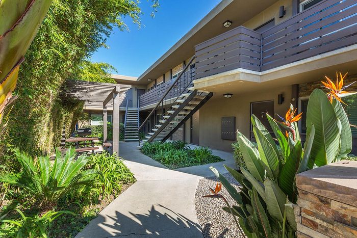 Lush tropical landscaping and walkways between buildings at Elan - beachlofts del mar
